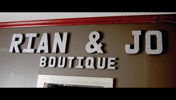 Staff Photo by Scott Thoma. The Rian & Jo Boutique sign inside the shop.