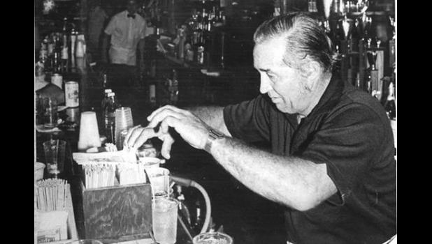Contributed photo Johnny Tillemans, the former owner/operator of the Silver Dollar Bar in Ghent, mixes drinks for customers during the establishment’s 50th anniversary in 1984. This photo, submitted by Jessica Gilbertson, won first place in this year’s Belgian-American Days Historical Photo Contest on Aug. 6.