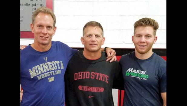 Special photo. Joel Skillings (left) and son Christian Skillings (right) with Olympian and national wrestling champion Tom Ryan of Ohio State.