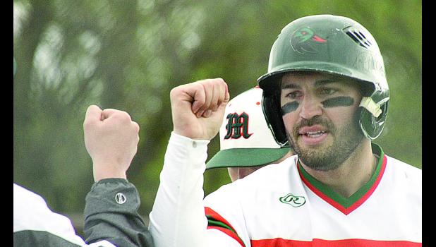 Staff Photo by Byron Higgin. Tyson Sonnenburg was congratulated by his teammates after his two-run, first inning home run.