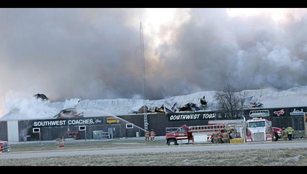 Staff Photo by Byron Higgin. Smoke poured out of the Southwest Coaches building.