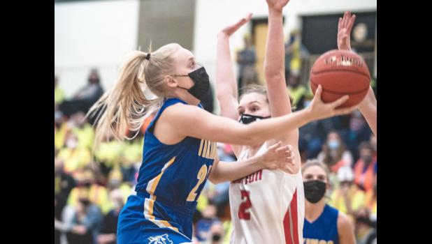 Mascot photo by Brian Jeremiason Abby Rost drives to the basket to score two of her nine points against Houston on Tuesday in Mankato.