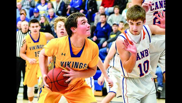 Photo by Brian Jeremiason. Logan Sussner eyes the basket against Canby's Tyler Sayre.