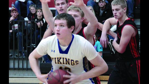 Staff Photo by Byron Higgin. Logan Sussner was surrounded by Fulda players, yet scored 27 points to help his team break the 100 mark Monday night in Fulda.