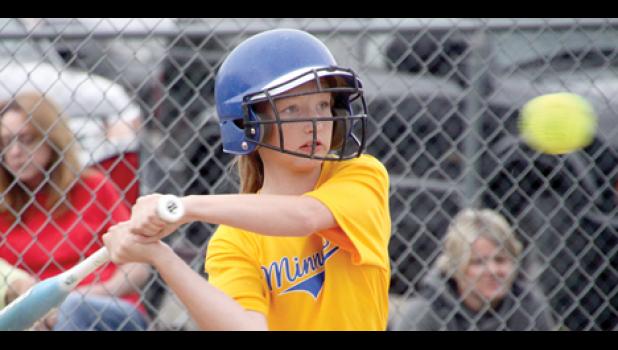 Staff Photo by Byron Higgin. With an eye on the ball, Kiersyn Hulzebos of the Minneota Summer Rec girls softball team prepared to let the bat fly against her Marshall opponents in recent action.