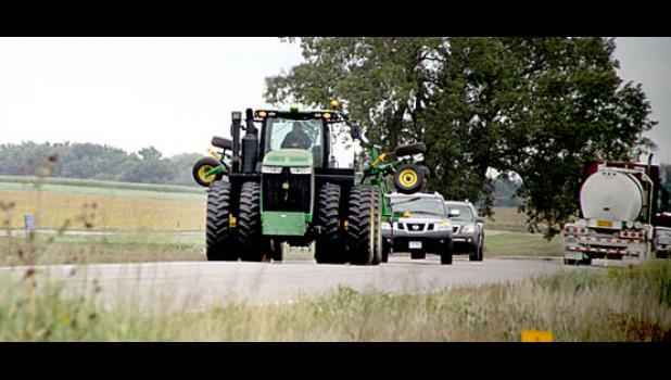 Staff Photo by Byron Higgin. Tractors will be on the roads and can create a potentially dangerous situation. This tractor was on Highway 68 between Minneota and Ghent last week. Drivers are urged to use plenty of room for the farm equipment.