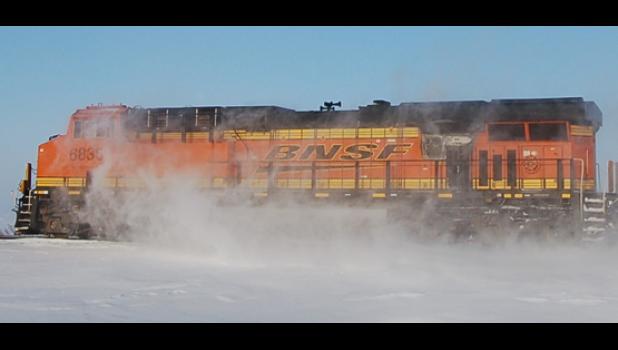 Staff Photo by Scott Thoma. You have to squint to watch the train going by along Highway 23, kicking up snow as it goes — but you could almost read, “The Polar Express” from the movie by the same name.