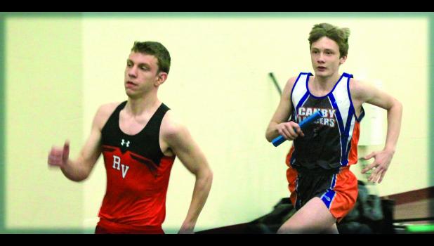 Staff Photo by Byron Higgin. Tristan Bierschenk (right) of Minneota eventually passed Redwood Valley and won the 4x800-meter relay event at Redwood Valley on Thursday.