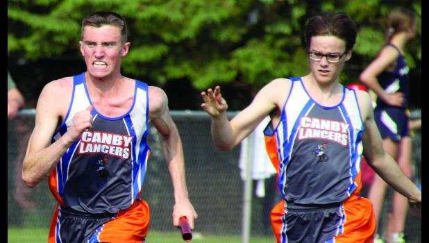 Staff Photo by Byron Higgin. Carter Wente took the baton from Cole VanOverbeke and put all his effort into his portion of the relay.