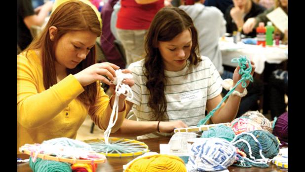 Photo for the Mascot by Sue Jacobson. Mariah Hennen and Summer Hennen were “hoop weaving” with balls of yarn.