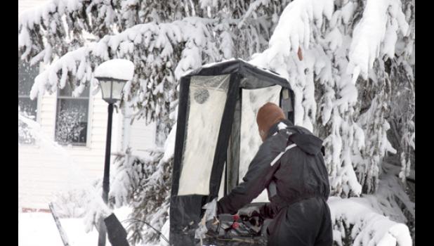 Staff photo by Byron Higgin All over town snow blowers were whizzing and twirling as snow flew in every direction.
