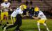 Minneota's Evan Jerzak (32), left, and Owen Myrvik (11) stop Lac qui Parle Valley quarterback Gavin Meyer after a short run Friday night in Madison. 