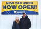 Abbie Yeo and Kyle Noyes pose in front of the Minneota Car Wash. 
