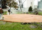 Staff Photo by Byron Higgin. Workers put the final touches on the new base for the upcoming Veteran's Memorial.
