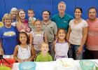 The volunteers served the food to the teachers. 