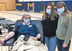 St. Edward School Principal Jaci Garvey donates blood with help from Minneota National Honor Society students Kaci Callens and Sylvia Rabaey. 