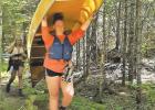 Ella Moorse portages to the next lake at the Boundary Waters Canoe Area. 
