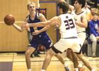 Max Rost, left, of Minneota looks for an open teammate to pass to while being guarded by two Yellow Medicine East players last Thursday in Minneota. 