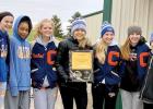 Holding the trophy they captured at the Camden Conference meet at Renville last week were: (left to right) Grace Drietz, Nohemi Diaz, Rachel Wollum, Faith Traen, McKenzie Ruether, Braelyn  Merritt and Claire Stoks. 