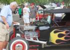 Mark Leese of Marshall wipes down his 1920 Ford Hotrod after a morning shower on Saturday during the Ghent Cruisers Car Show. 