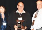 Special photo. Receiving his award was Commissioner Sanow (center), UCAP Transportation Director Cathleen Amick (left) and MPTA President Craig Remp.