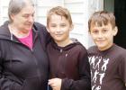 Grandmother Brenda Rolfes looks lovingly at her twin grandsons, Chase, middle, and Kallen, right, on her birthday on Saturday.