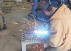 Chase Laleman, 15, works on a replica of a gatling gun in the garage at his parent's home south of Minneota. 
