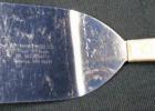 This spatula is engraved with “Dr. Kerr’s Feed Co. Triple “F” Feeds Ph: 507-872-6113 Taunton, MN. 56291” on the blade.