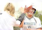 Sydney Larson was congratulated by Coach Heidi Boerboom after she hit a home run in the 9-4 playoff-opening win over Montevideo Thursday.