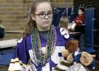 Kylie Callens of the St. Edward School carried off some of her winnings from the Mardi Gras Friday. It was part of the National Education Week festivities at the local Catholic School.