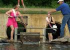 2023-24 Boxelder Bug Days queen Kylee Loyson and Second Princess Hannah Heidecker retrieve ducks from the river at Countryside Golf Club with the help of Scott Josephson during the annual Duck Race last week. 