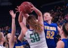 Minneota's Lydia Sussner fought 6-5 Kristi Fett of Lyle-Pacelli, but it ended up being a losing battle and the Athletics won, 53-41. Lizzy Gillingham also fought for the ball against the 6-5 Fett.