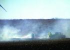 Staff Photo by Byron Higgin. Firemen tried to stave off the fire.