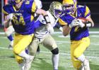 Drew Lipinski, right, follows lineman Kyson Arndt (64) during a running play Friday against Braham. 