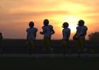Minneota Vikings assistant football coach Matt Myrvik addresses his offensive lineman as the sun sinks lower in the west last Thursday night in Madison where the Vikings took on Lac qui Parle Valley. Minneota won 81-0. See Page 3.