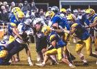 Minneota gang-tackles Eden Valley-Watkins running back LaMichael Artis. 