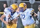Sawyer DeSmet, left, is congratulated by his older brother, Landon DeSmet, after catching his first touchdown pass on varsity. 
