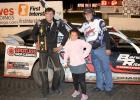 Garet DeBoer  poses by his car after winning a feature race at I-90 Speedway in Hartford, SD this summer.