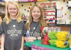  Addyson Pohlen, left, and Brisbyn Traen of Minneota Girl Scouts Troop 37814 remove their facial masks to pose for a photo next to their cookie stand at the C-Store. The girls sold over 60 boxes on Saturday. They will next be selling cookies on Saturday, Feb. 27 from 9 a.m. to noon at the Hy-Vee store in Marshall.