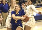 Grace Hennen (2) of Minneota drives between two Southwest Christian defenders as she heads to the basket last Tuesday in Minneota. 