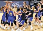 The Minneota girls basketball team hoists the Class A state championship trophy after defeating Belgrade-Brooten-Elrosa 48-45 in the finals last Friday at Target Center. 