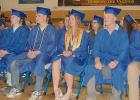 Graduating seniors listen to a speaker on stage during the 122nd commencement program at Minneota High School on Saturday. Left to right: Sarah Gruenes, Noah Harms, Leo Hennen, Madison Hennen, Carson Javers, and Emerson Johnson. 