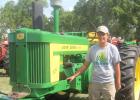 Zach Hennen stands beside the 1957 John Deere 720 he restored recently. Hennen displayed the tractor during Harvest Festival on Saturday in Porter. 