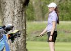 Carolyn Hoffmann watches the flight of her ball after hitting it toward the green. File Photo.