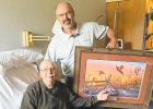 Dale Sterzinger, manager of the Lincoln Soil and Water Conservation District, presents a Pheasants Forever print to John Boulton, retired Lincoln Soil and Water Conservation District Supervisor, for his 56 years of service as a supervisor/board member. 