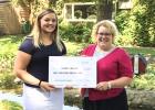 Sydney Larson (left) receives a scholarship from the Care Providers of Minnesota Foundation from Jill Schewe, Care Providers of Minnesota Housing Director.