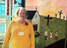Jennifer Warnock poses beside a Prairie Conference sign that Hope Lutheran Church is a part of in the Southwest Minnesota Synod. 