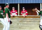 Catcher Jesse Drager made a putout as his teammates Danny Hennen (left) and Zach Nuy looked on — as did the Ortonville players.