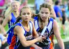 Kameron King took the hand-off from RyAnn Hansen during the 4x400-meter relay at Granite Falls on Thursday.