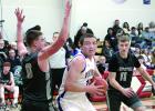 Staff Photo by Byron Higgin Logan Sussner drove to the basketball against Heron Lake-Okabena-Fulda defenders Tyler Madson (0) and Eli Fest (11).